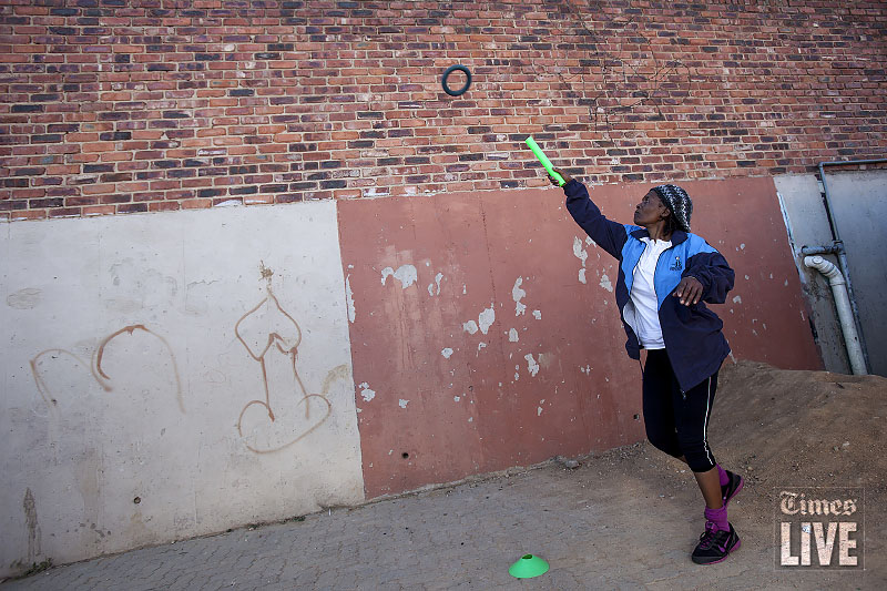 A woman practices the ring throw before the start of the Active Ageing older persons games for the elderly over 60 years of age in Alexandra township, Johannesburg. 380 people took part in the event which saw people which are over 60 years in age from Gauteng compete against each other in various track and field events. The events included the 100m - 800m track events, jukskei, rugby throw and pass the ball. Aug 2013